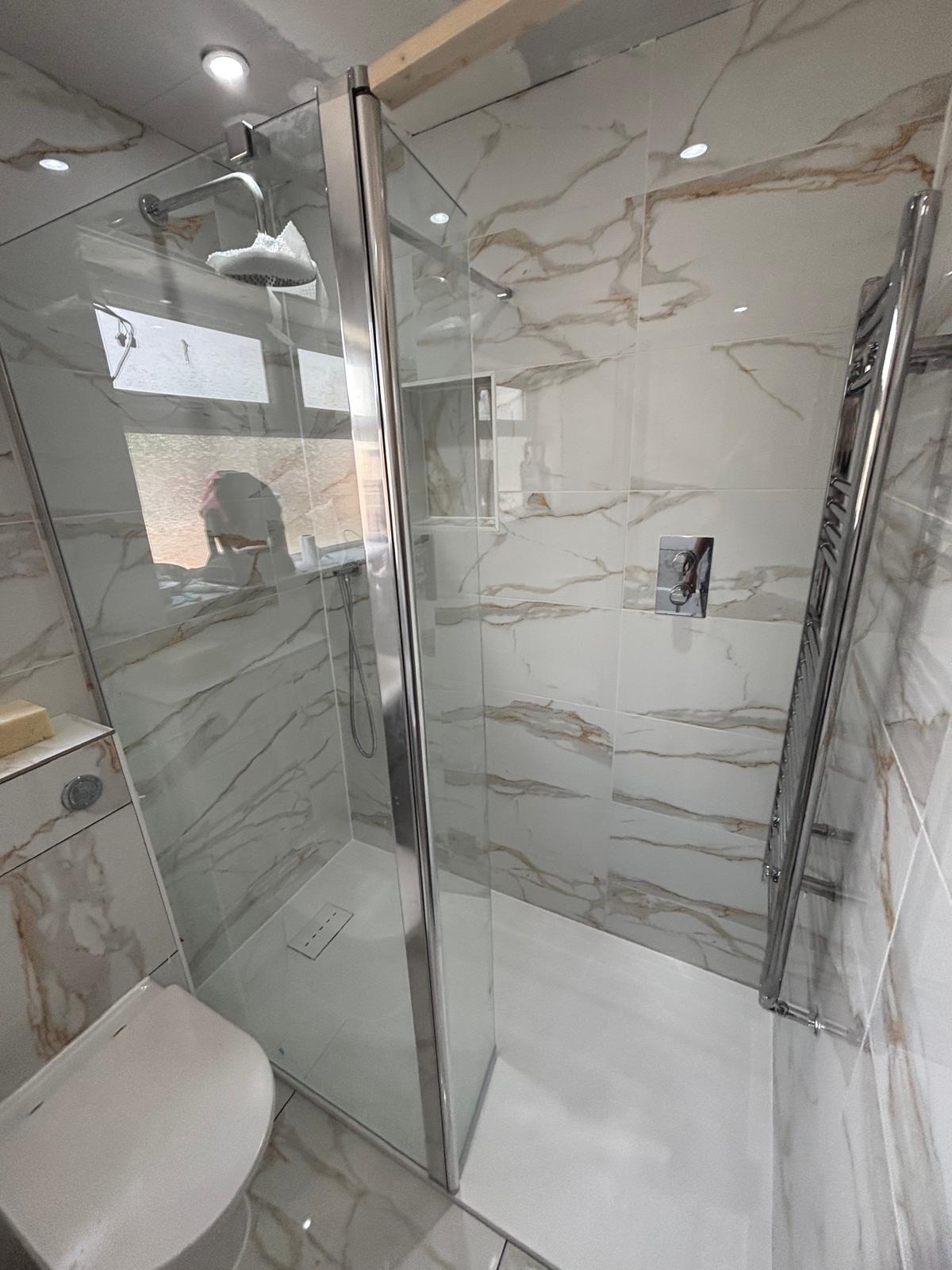 Calacatta gold marble-effect tiled walk-in shower